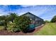 Screened pool and spa with patio furniture, lush landscaping, and a spacious backyard at 8773 Stone Harbour Loop, Bradenton, FL 34212