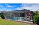 Enclosed pool and spa with patio furniture under a screened enclosure at 8773 Stone Harbour Loop, Bradenton, FL 34212