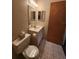 Clean bathroom with single sink vanity, toilet, and tiled floor at 975 S Tuttle Ave, Sarasota, FL 34237