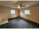 Spacious carpeted bedroom with two large windows and ceiling fan at 975 S Tuttle Ave, Sarasota, FL 34237