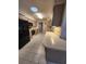 Galley style kitchen with black appliances and light wood cabinets at 975 S Tuttle Ave, Sarasota, FL 34237