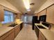 Simple kitchen with light wood cabinets, tiled floor, and standard appliances at 975 S Tuttle Ave, Sarasota, FL 34237