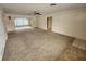 Spacious living room featuring carpeted floors and a ceiling fan at 975 S Tuttle Ave, Sarasota, FL 34237