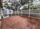 Spacious screened patio with brick tile floor, perfect for outdoor relaxation at 975 S Tuttle Ave, Sarasota, FL 34237