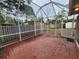 Large screened patio with brick tile floor and backyard access at 975 S Tuttle Ave, Sarasota, FL 34237
