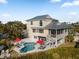 House with pool and lush landscaping near the water at 114 Gull Dr, Anna Maria, FL 34216