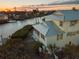 Elevated view of waterfront home at sunset at 114 Gull Dr, Anna Maria, FL 34216