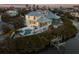 Elevated view of waterfront home, pool, and private dock at sunset at 114 Gull Dr, Anna Maria, FL 34216