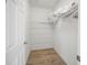 Walk-in closet with wire shelving and wood floor at 114 Gull Dr, Anna Maria, FL 34216