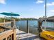 Waterfront dock with a kayak and umbrella at 114 Gull Dr, Anna Maria, FL 34216