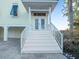 Front entrance with white stairs and double doors at 114 Gull Dr, Anna Maria, FL 34216