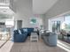 Spacious living room features a comfortable sectional sofa and access to a waterfront deck at 114 Gull Dr, Anna Maria, FL 34216