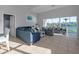 Open living space with sectional sofa, water views, and access to outdoor deck at 114 Gull Dr, Anna Maria, FL 34216