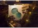 Night view of kidney-shaped pool and patio furniture at 114 Gull Dr, Anna Maria, FL 34216