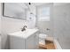 Modern bathroom with white marble tile and gray vanity at 1010 E Lake Ave, Tampa, FL 33605