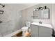 Modern bathroom with marble shower, gray vanity, and a stylish mirror at 1010 E Lake Ave, Tampa, FL 33605