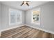 Bright bedroom with wood-look floors and ceiling fan at 1010 E Lake Ave, Tampa, FL 33605