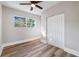 Bedroom with wood-look floors, ceiling fan and window at 1010 E Lake Ave, Tampa, FL 33605