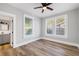 Main bedroom with wood-look floors, ceiling fan and bathroom access at 1010 E Lake Ave, Tampa, FL 33605