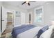 Bright bedroom with wood-look floors, and access to bathroom and additional room at 1010 E Lake Ave, Tampa, FL 33605