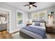 Main bedroom with wood-look floors, ceiling fan and bathroom access at 1010 E Lake Ave, Tampa, FL 33605