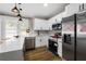 Modern white kitchen with stainless steel appliances and island at 1010 E Lake Ave, Tampa, FL 33605