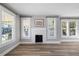 Living room with hardwood floors and a white brick fireplace at 1010 E Lake Ave, Tampa, FL 33605