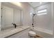 Bathroom with granite countertop, white cabinets, and bathtub at 10508 Mcalester Cir, Port Charlotte, FL 33981