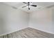 Bedroom with wood-look floors and ceiling fan at 10508 Mcalester Cir, Port Charlotte, FL 33981