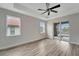 Spacious bedroom with wood-look floors, ceiling fan, and sliding glass doors leading to a patio at 10508 Mcalester Cir, Port Charlotte, FL 33981