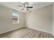 Bright bedroom with wood-look floors and ceiling fan at 10508 Mcalester Cir, Port Charlotte, FL 33981