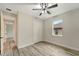 Bedroom with wood-look floors, ceiling fan, and double doors to closet at 10508 Mcalester Cir, Port Charlotte, FL 33981