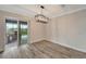 Bright dining room with wood-look floors and access to the backyard patio at 10508 Mcalester Cir, Port Charlotte, FL 33981