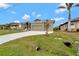 Exterior view of house, showcasing the driveway and landscaping at 10508 Mcalester Cir, Port Charlotte, FL 33981