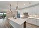 Modern kitchen island with white quartz countertops and black cabinets at 10508 Mcalester Cir, Port Charlotte, FL 33981