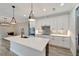 White quartz countertop kitchen island with a black farmhouse sink at 10508 Mcalester Cir, Port Charlotte, FL 33981