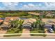 Aerial view of three homes with lush landscaping at 11241 Sandhill Preserve Dr, Sarasota, FL 34238