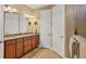 Double vanity bathroom with granite countertop and large mirror at 11241 Sandhill Preserve Dr, Sarasota, FL 34238