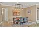 Bright dining room featuring a wood table and modern light fixtures at 11241 Sandhill Preserve Dr, Sarasota, FL 34238