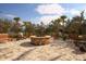 Relaxing fire pit area with seating and landscaping at 11241 Sandhill Preserve Dr, Sarasota, FL 34238