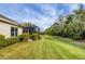 Backyard view showcasing a screened patio and well-maintained lawn at 11808 Sawgrass Lake Ter, Bradenton, FL 34211