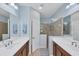 Double vanity bathroom with large shower and dark brown cabinets at 11808 Sawgrass Lake Ter, Bradenton, FL 34211