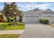 Two-car garage, attractive landscaping, and a paved driveway at 11808 Sawgrass Lake Ter, Bradenton, FL 34211