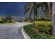 Residential home with a curved driveway and lush landscaping at night at 11808 Sawgrass Lake Ter, Bradenton, FL 34211