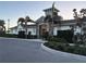 Clubhouse exterior with stone accents, palm trees, and well-maintained landscaping at 12571 Night View Dr, Sarasota, FL 34238