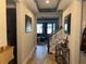 Inviting hallway with wood-look tile flooring and staircase leading to the upper level at 12571 Night View Dr, Sarasota, FL 34238