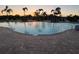 Community pool at sunset featuring lounge chairs and clear water at 12571 Night View Dr, Sarasota, FL 34238