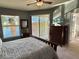 Main bedroom with lake views, dresser, and access to balcony at 1274 Burgos Dr # 1101, Sarasota, FL 34238