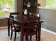 Charming dining room with wooden table and chairs, near window at 1274 Burgos Dr # 1101, Sarasota, FL 34238