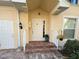 Front entrance with stairs, brick walkway, and potted plants at 1274 Burgos Dr # 1101, Sarasota, FL 34238